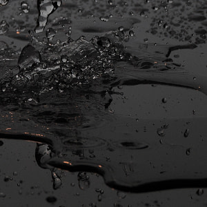 Wet & Messy - Clear fluid splashing on black background
