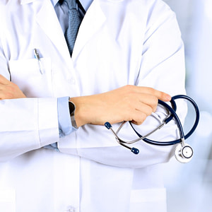 Torso of doctor in white coat holding stethoscope illustrating a post on medical fetishism