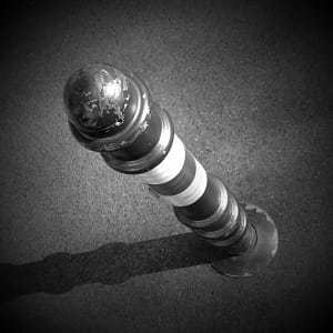 Black and white picture of a lighthouse sale dildo to illustrate pegging